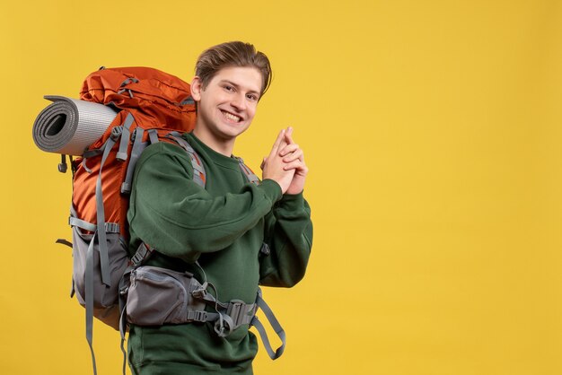 Front view young male with backpack preparing for hiking