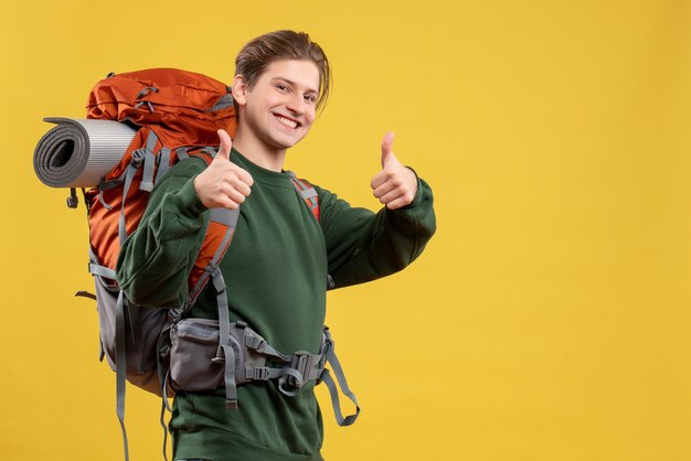 Front view young male with backpack preparing for hiking