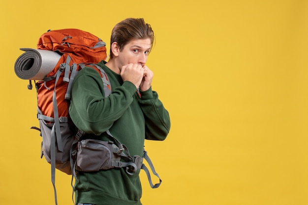 Front view young male with backpack preparing for hiking