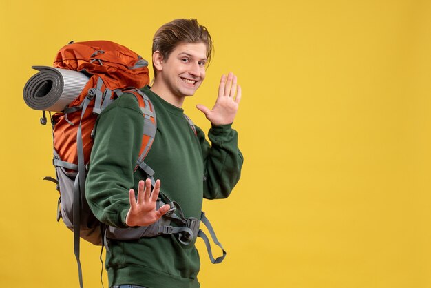 Front view young male with backpack preparing for hiking