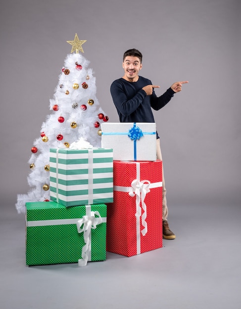 Front view young male with christmas presents on a light