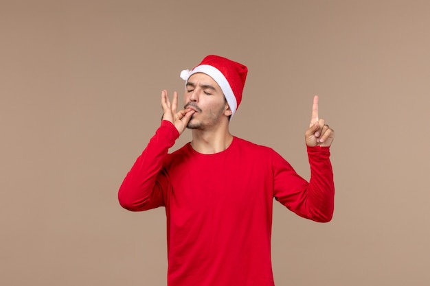 Front view young male with delighted face on brown background holiday christmas emotions