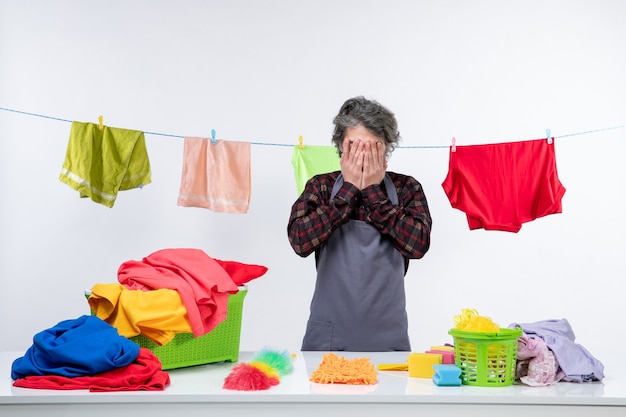 Front view young male with different clean clothes and towels on a white background