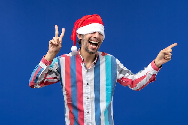 Front view young male with excited expression on blue desk holiday emotion male