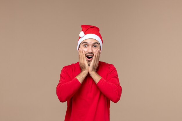 Front view young male with excited expression on brown background male emotions holiday color