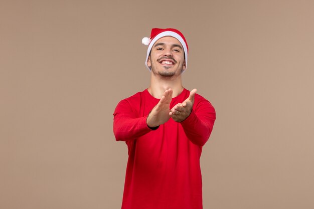 Front view young male with excited expression on brown desk christmas emotion holiday