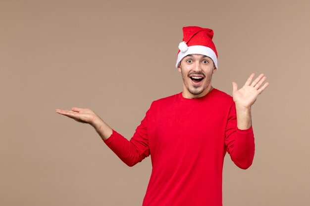 Front view young male with excited expression on brown desk christmas emotions holiday