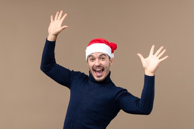 Front view young male with excited expression on brown desk emotion christmas holiday