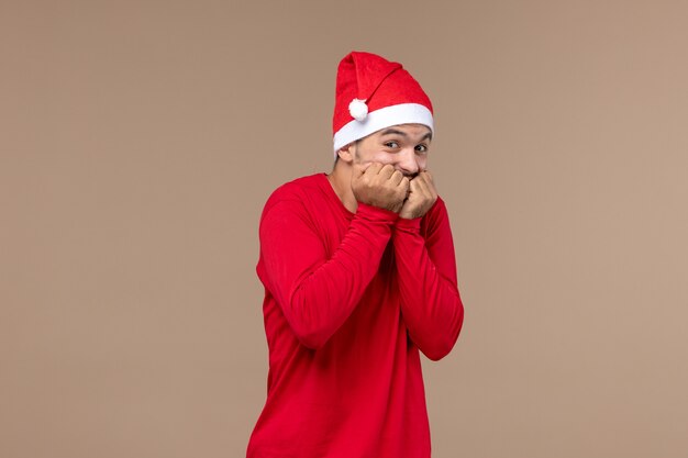 Front view young male with excited expression on a brown desk holiday male emotion