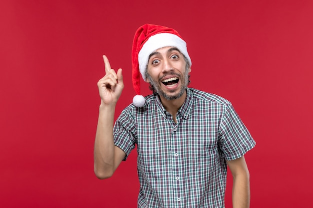 Front View Young Male with Excited Expression on Red Background