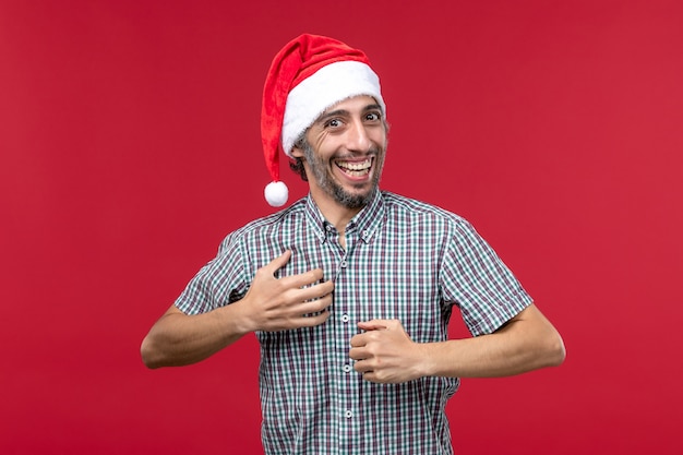 Front view young male with excited expression on red background