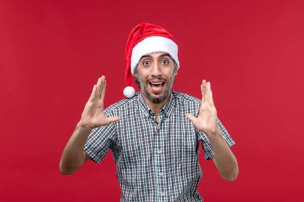 Front view young male with excited expression on red background