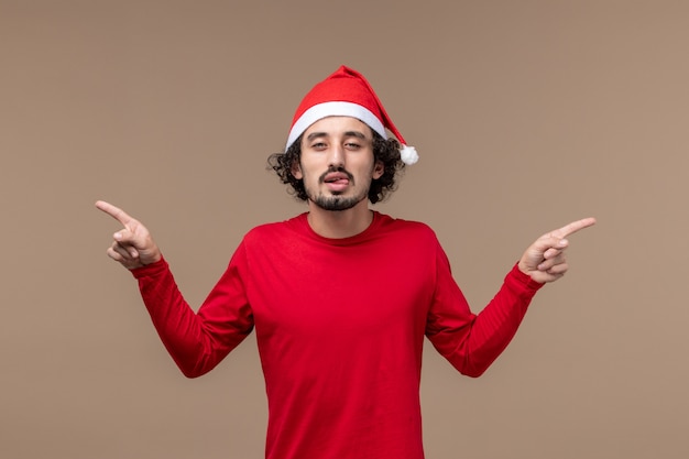 Front view young male with funny expression on brown background emotion christmas holiday