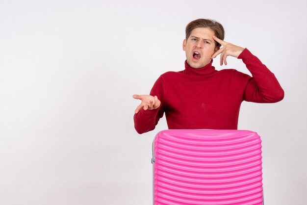 Front view young male with pink bag on a white background