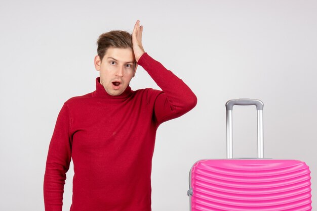 Front view young male with pink bag on the white background