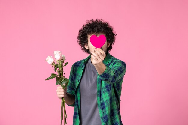 Front view young male with pink roses and heart sticker on pink