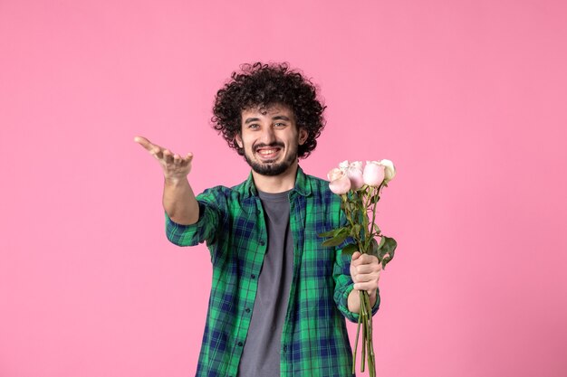 Front view young male with pink roses on pink color