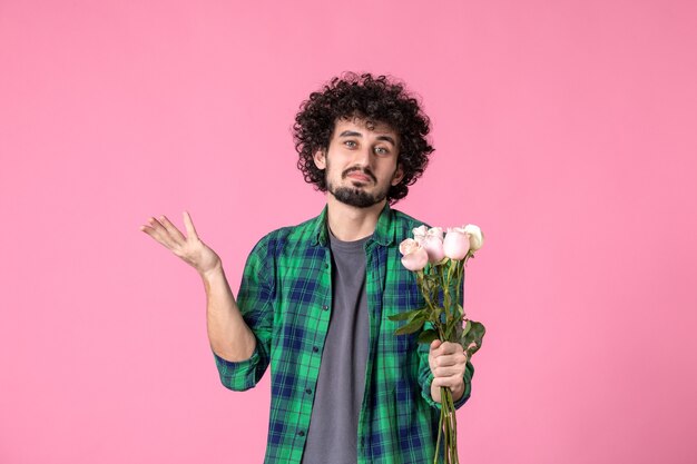 Front view young male with pink roses on pink color