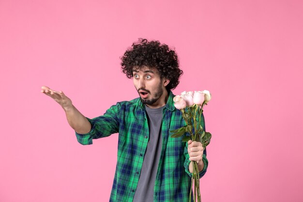 Front view young male with pink roses on pink color