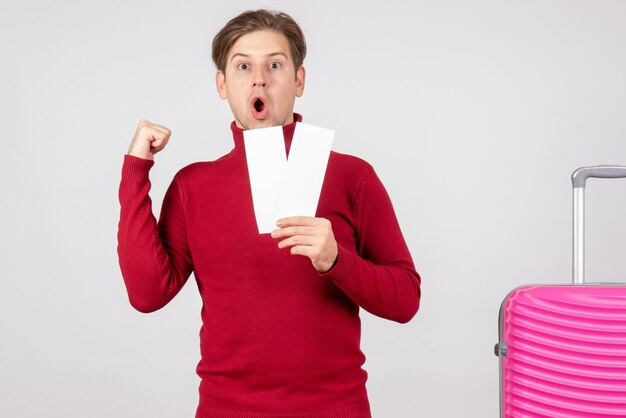 Front view young male with plane tickets on white background