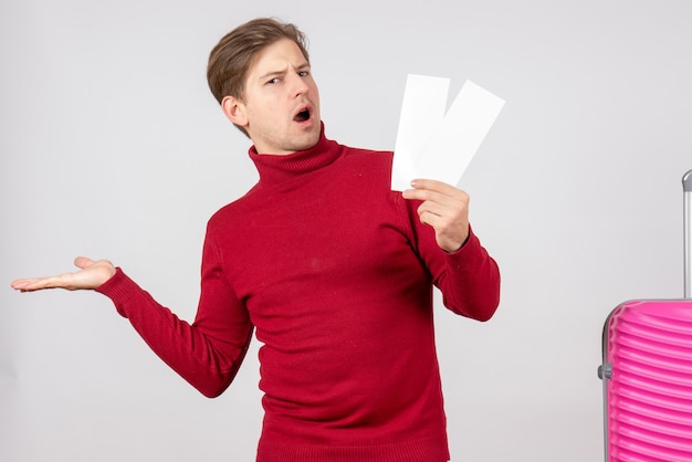 Front view young male with plane tickets on white background