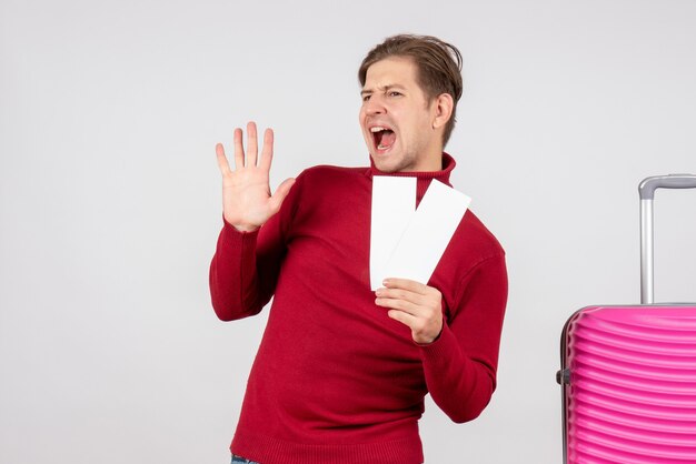 Front view young male with plane tickets on white background