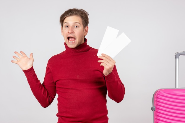 Front view young male with plane tickets on white background