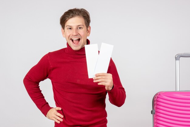 Front view young male with plane tickets on white background