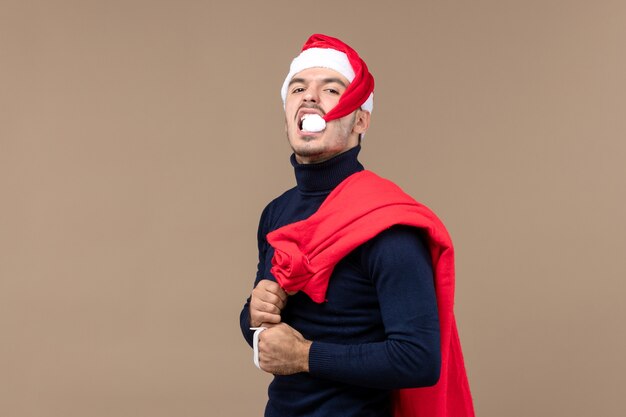 Front view young male with present bag, christmas holiday santa