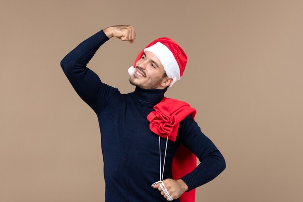 Front view young male with present bag, christmas holidays santa