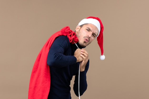 Front view young male with present bag, holiday emotion christmas