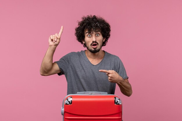 Front view young male with red bag on pink space