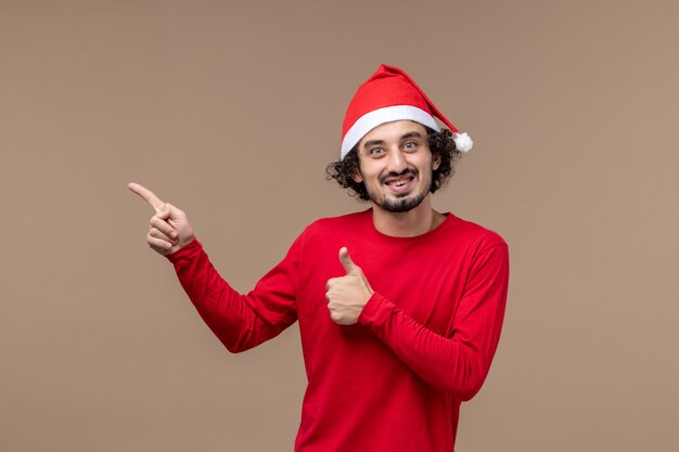 갈색 책상 감정 휴일 크리스마스에 빨간 크리스마스 케이프와 전면보기 젊은 남성