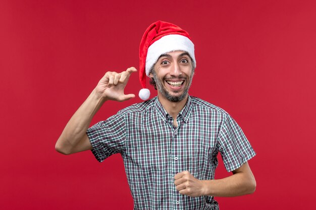 Front view young male with smiling expression on red background