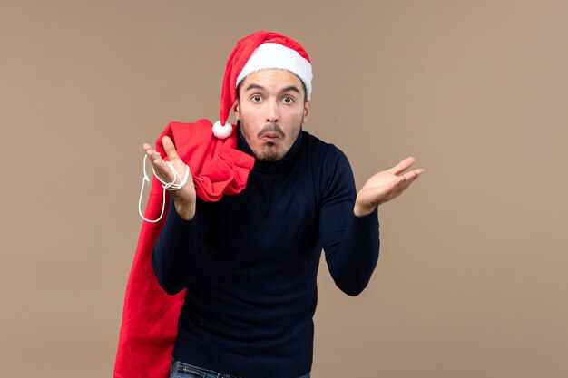 Front view young male with surprised expression, christmas holiday santa