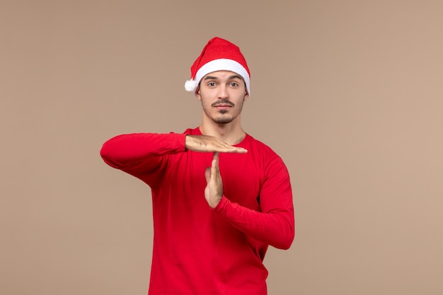 Front view young male with thinking expression on a brown background emotion christmas holiday