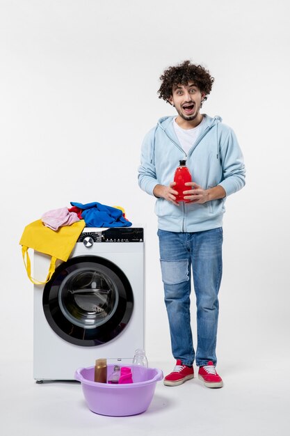 Front view of young male with washer on the white wall