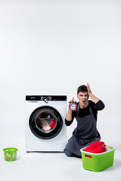 Front view of young male with washer on white wall