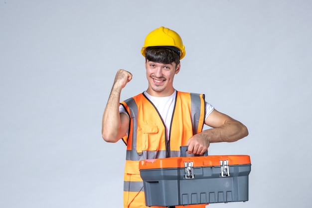 front view young male worker with tool case on white background