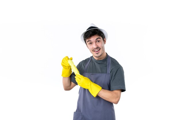 Front view young male in yellow gloves on white background flower bush plant grass tree gardener green job