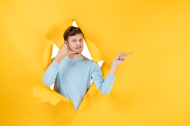 Front view young male on yellow ripped background