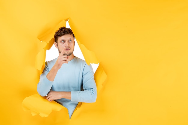 Front view young male on yellow ripped background