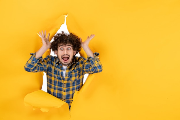 Front view young male on yellow ripped background