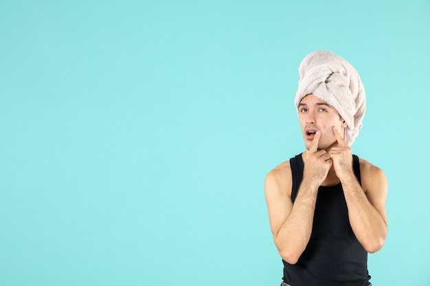 Free photo front view of young man after shower on blue wall