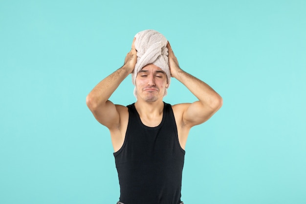 Free photo front view of young man after shower on blue wall