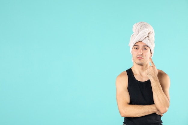 Free photo front view of young man after shower on blue wall