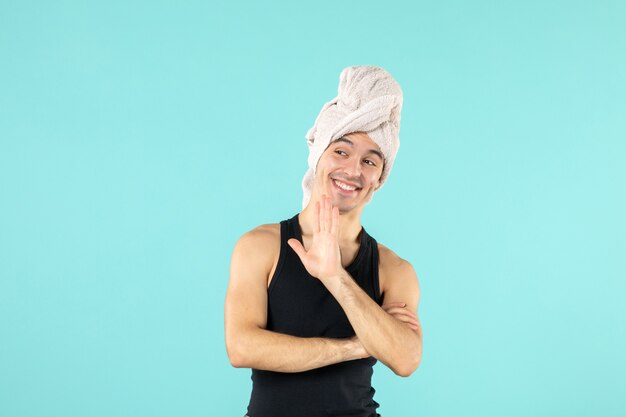 Free photo front view of young man after shower on blue wall