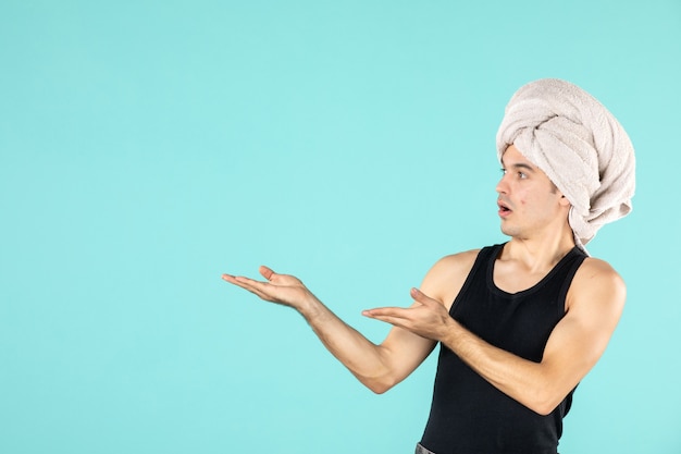 Free photo front view of young man after shower on blue wall