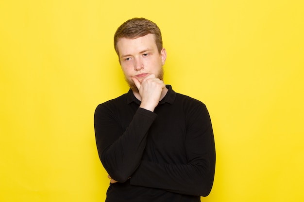 Free photo front view of young man in black shirt with thinking expression on his face