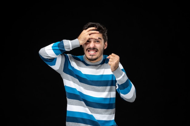 Front view young man in blue striped jersey with frustrated expression